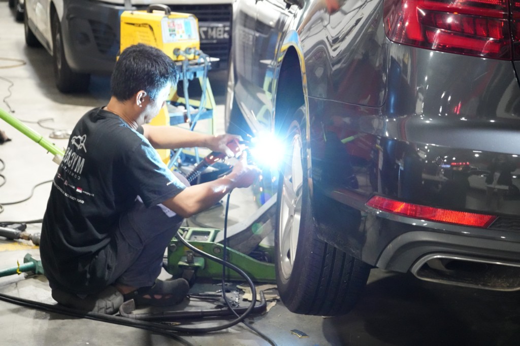 A mechanic working on a car at the My Car Consultant workshop